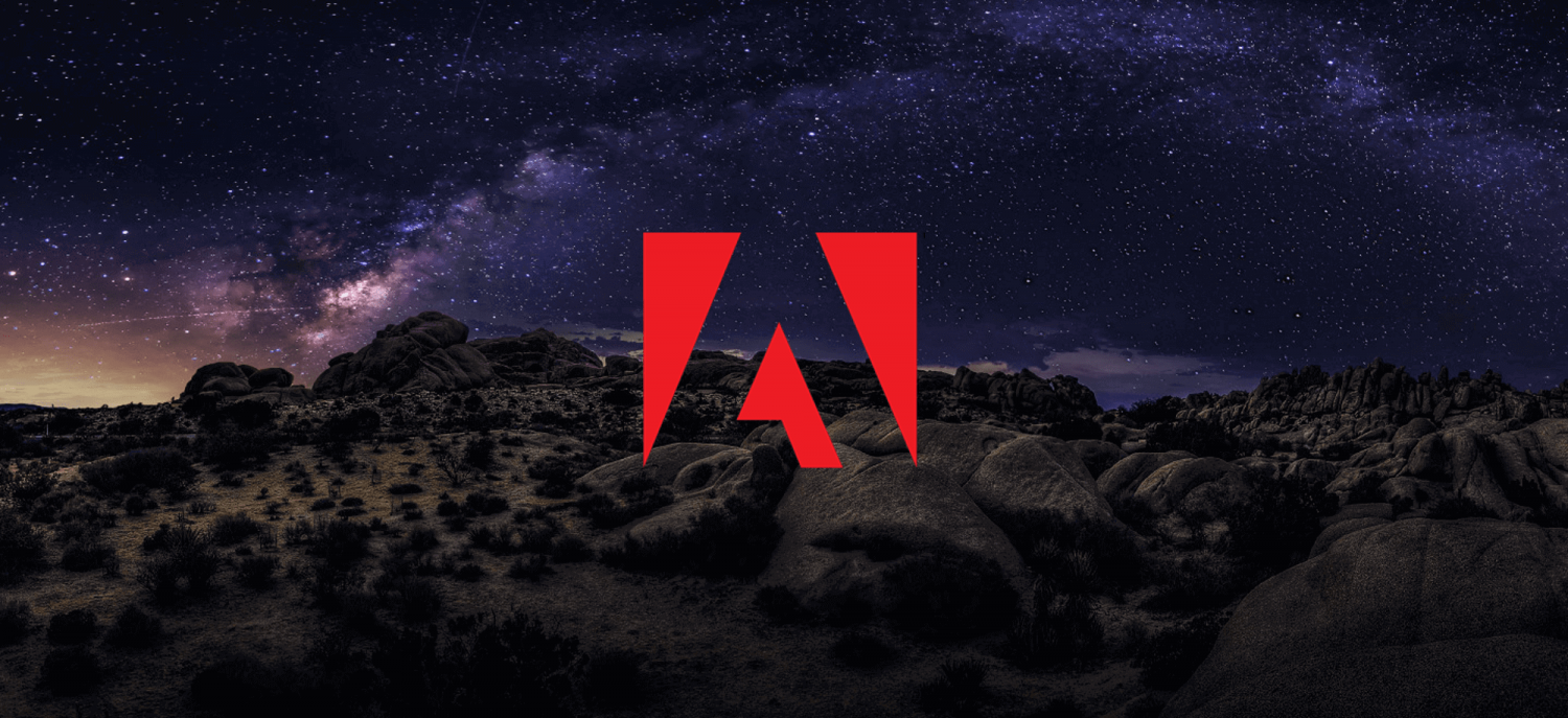 Adobe logo above a town at night