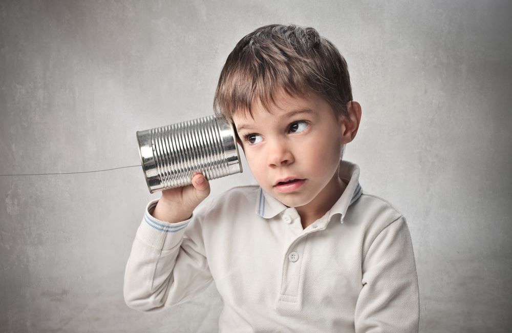 Boy with can to his ear