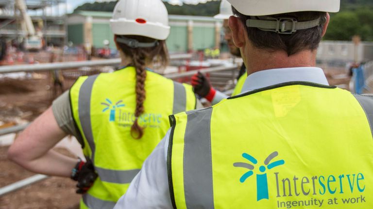 Interserve workers in high vis and hard hats on a construction site