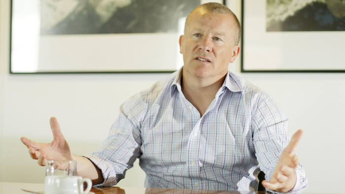 Neil Woodford looks worried as he sits in a boardroom 