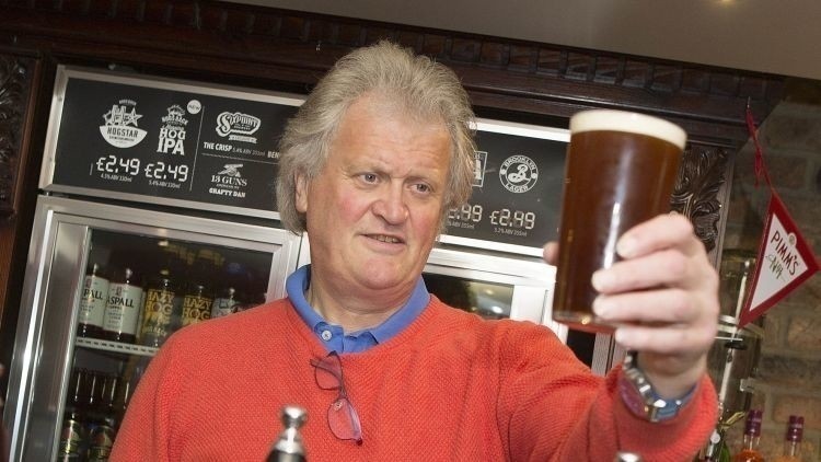 Tim Martin, founder of Wetherspoons in a pub with a pint