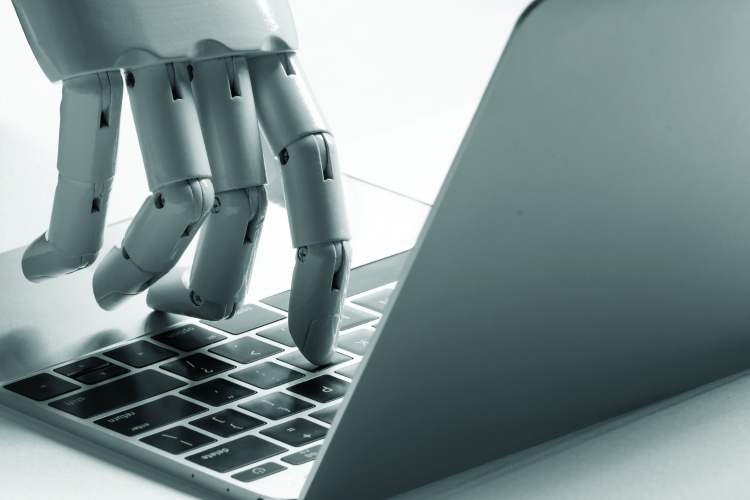 Robot hand using a laptop 